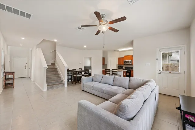 a living room with furniture and kitchen view