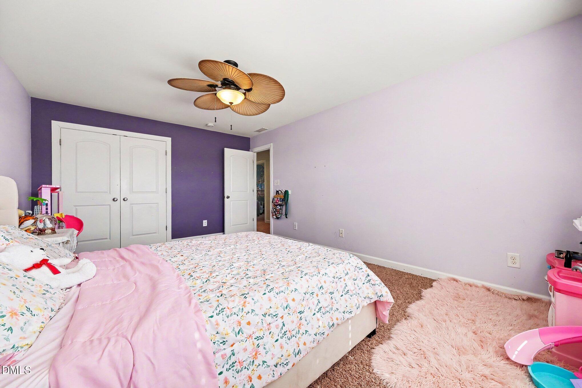 4000 Banks Stone Drive Raleigh, NC 27603 - Photo 28 of 60 a bedroom with a bed and a chandelier