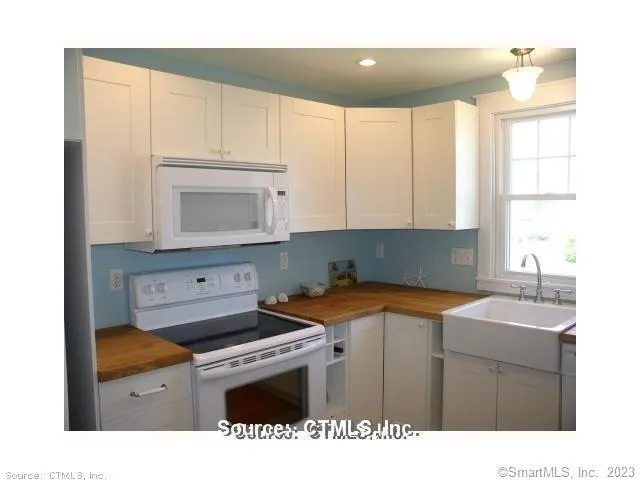 a kitchen with a sink a stove and cabinets