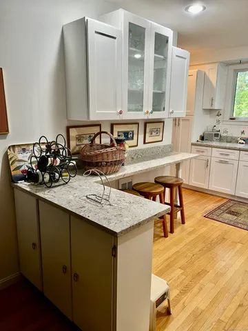 a kitchen with a sink a stove and chairs