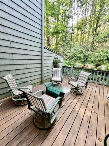 a view of balcony with wooden floor and outdoor seating