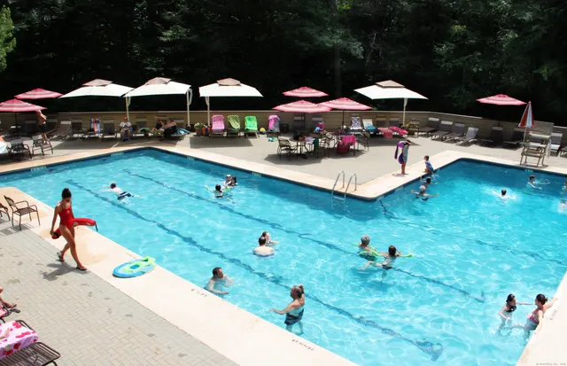 an outdoor space with lots of swimming pool and furniture