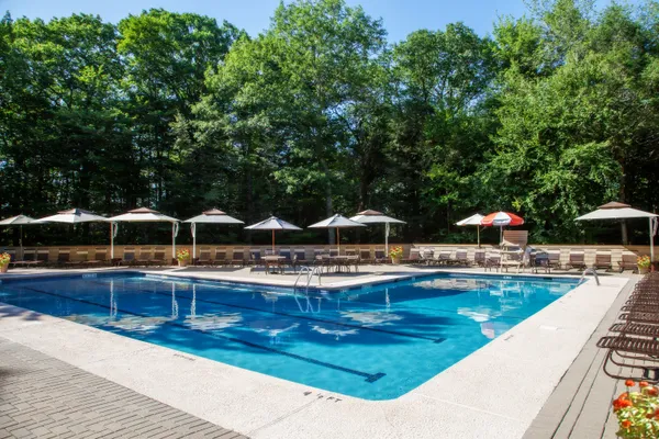 an outdoor space with lots of swimming pool and furniture