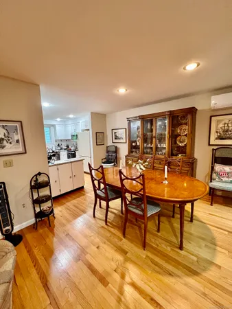 a living room with furniture a rug and kitchen view