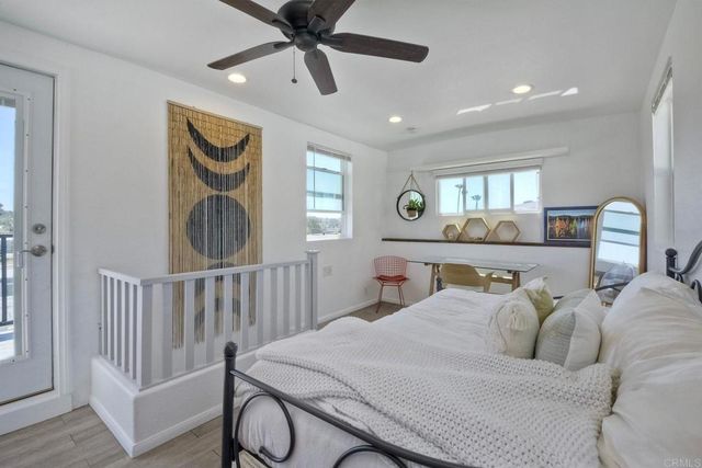 a bedroom with two beds and a chair