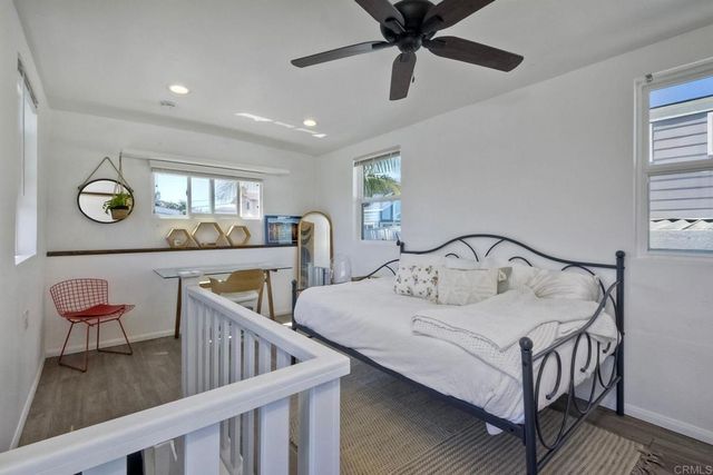 a roof deck with a table and chairs and wooden floor