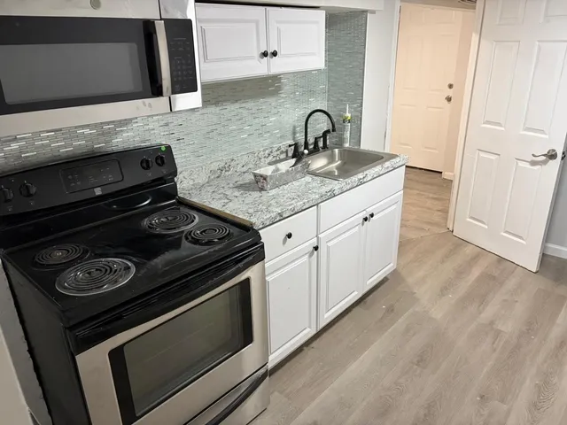 a kitchen with a stove and a sink