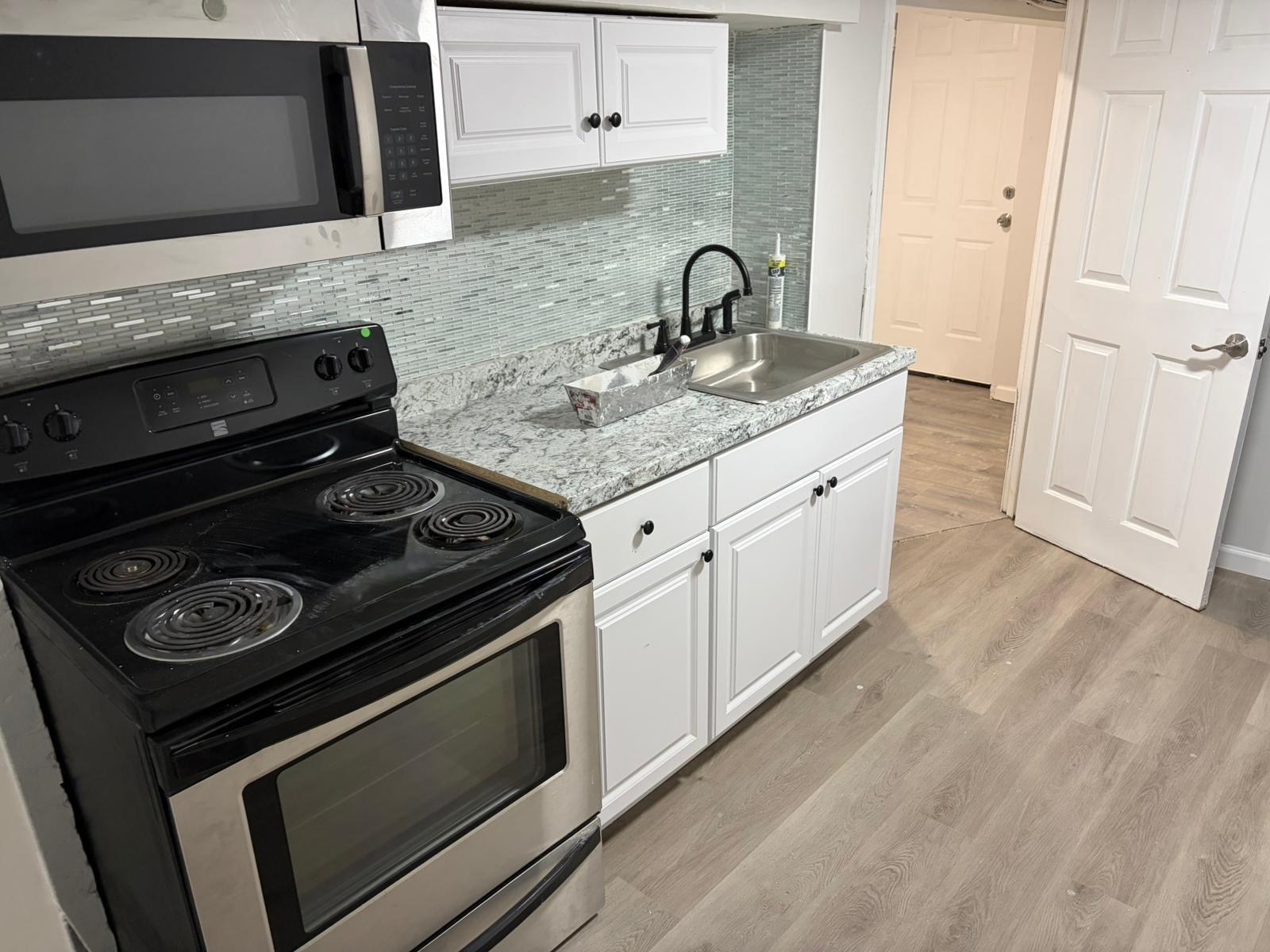 a kitchen with a stove and a sink