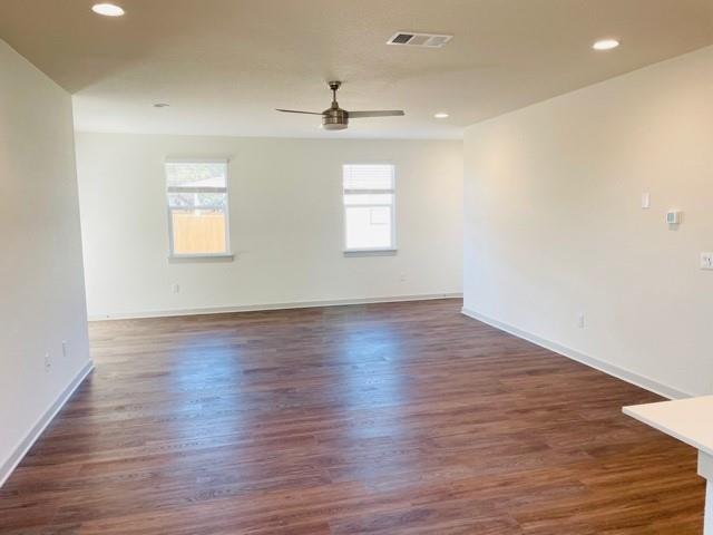 161 Filifera Court Leander, TX 78641 - Photo 5 of 13 Empty room with ceiling fan, dark wood-style floors, baseboards, and recessed lighting