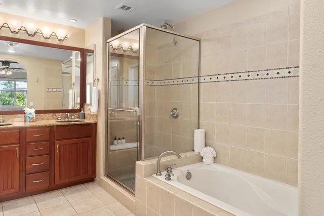 a bathroom with a bathtub shower sink and mirror