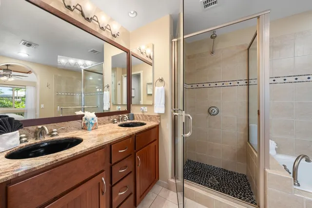 a bathroom with a sink double vanity and shower