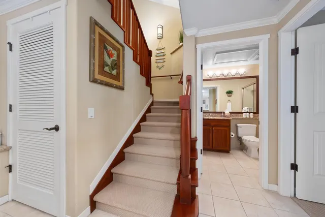 a view of a hallway with wooden floor and a living room