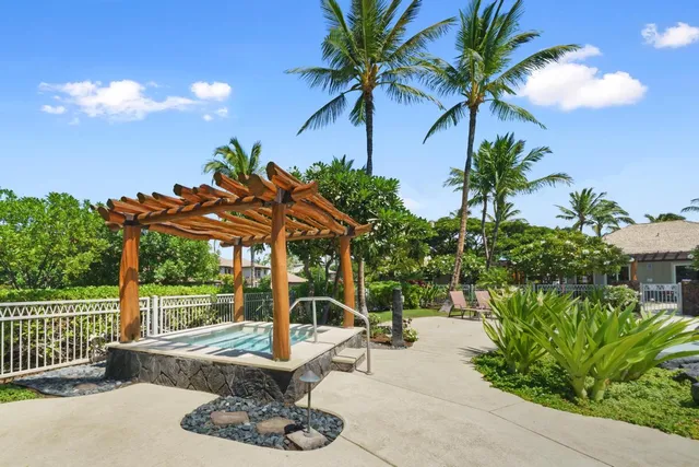 a view of a patio with table and chairs potted plants and palm tree