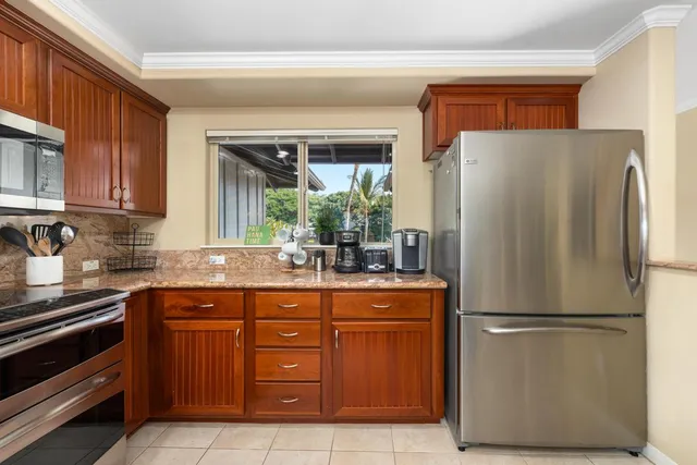 a kitchen with stainless steel appliances granite countertop a refrigerator and a sink