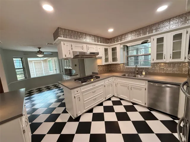 a kitchen with a stove a sink and a refrigerator