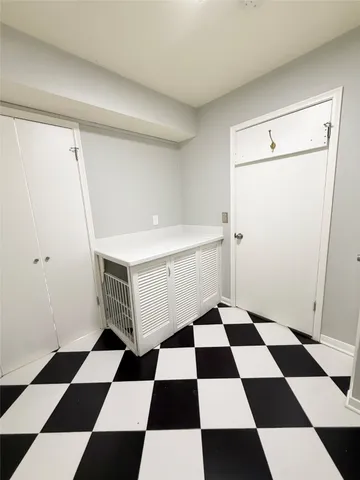 a bedroom with a balcony a black and white checkered floor