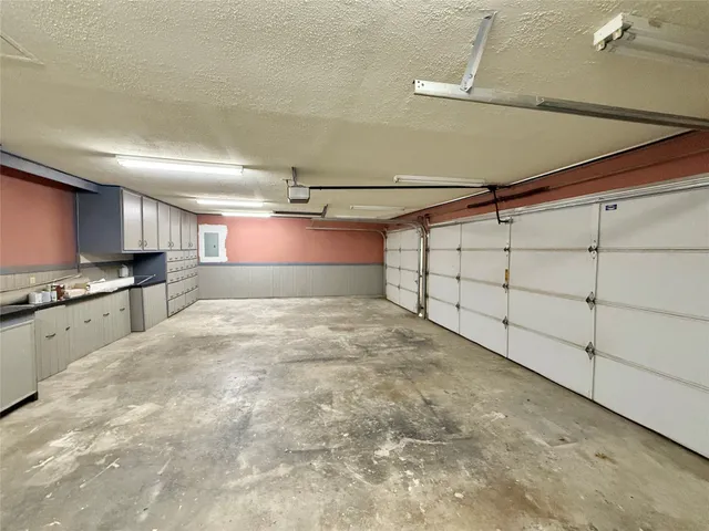 a kitchen with granite countertop a sink and a stove