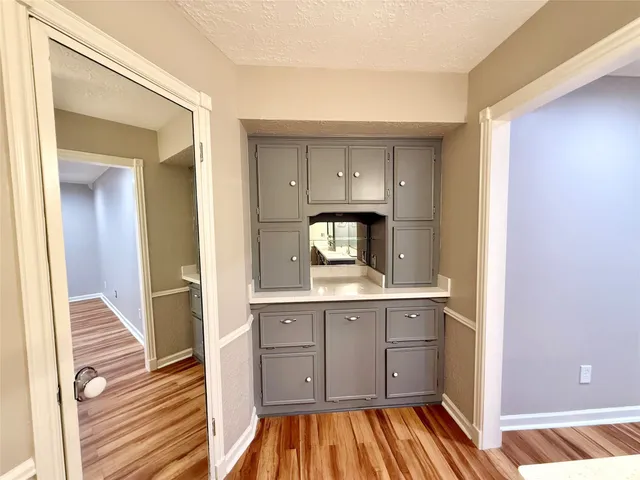 a view of a room with wooden floor