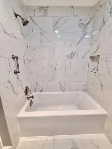 a view of a hallway with wooden floor and stairs