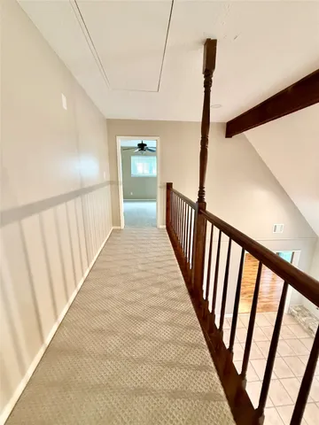 a view of a patio with table and chairs under an umbrella
