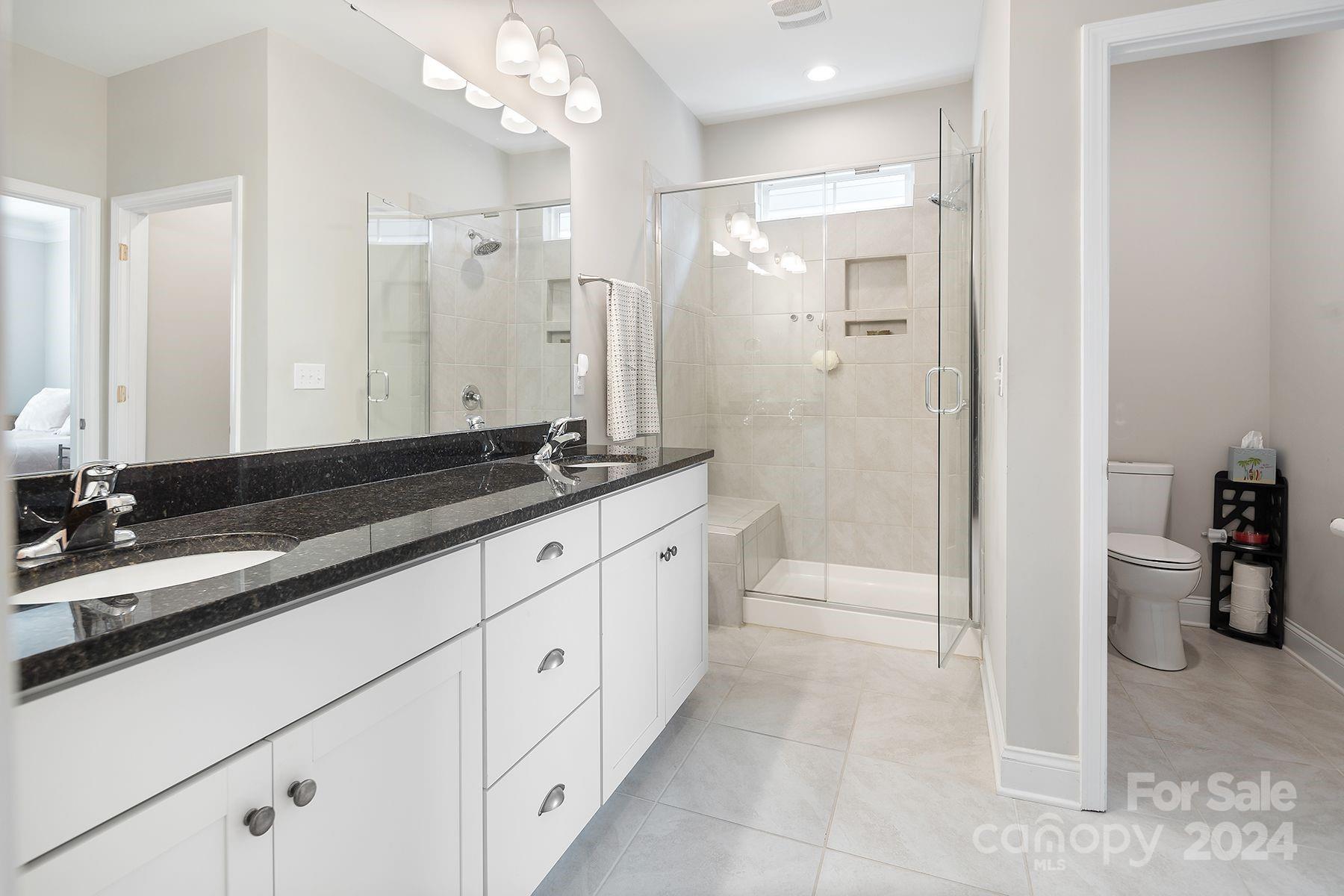 118 East Northstone Road Mooresville, NC 28115 - Photo 15 of 33 a spacious bathroom with a granite countertop sink mirror and a bathtub