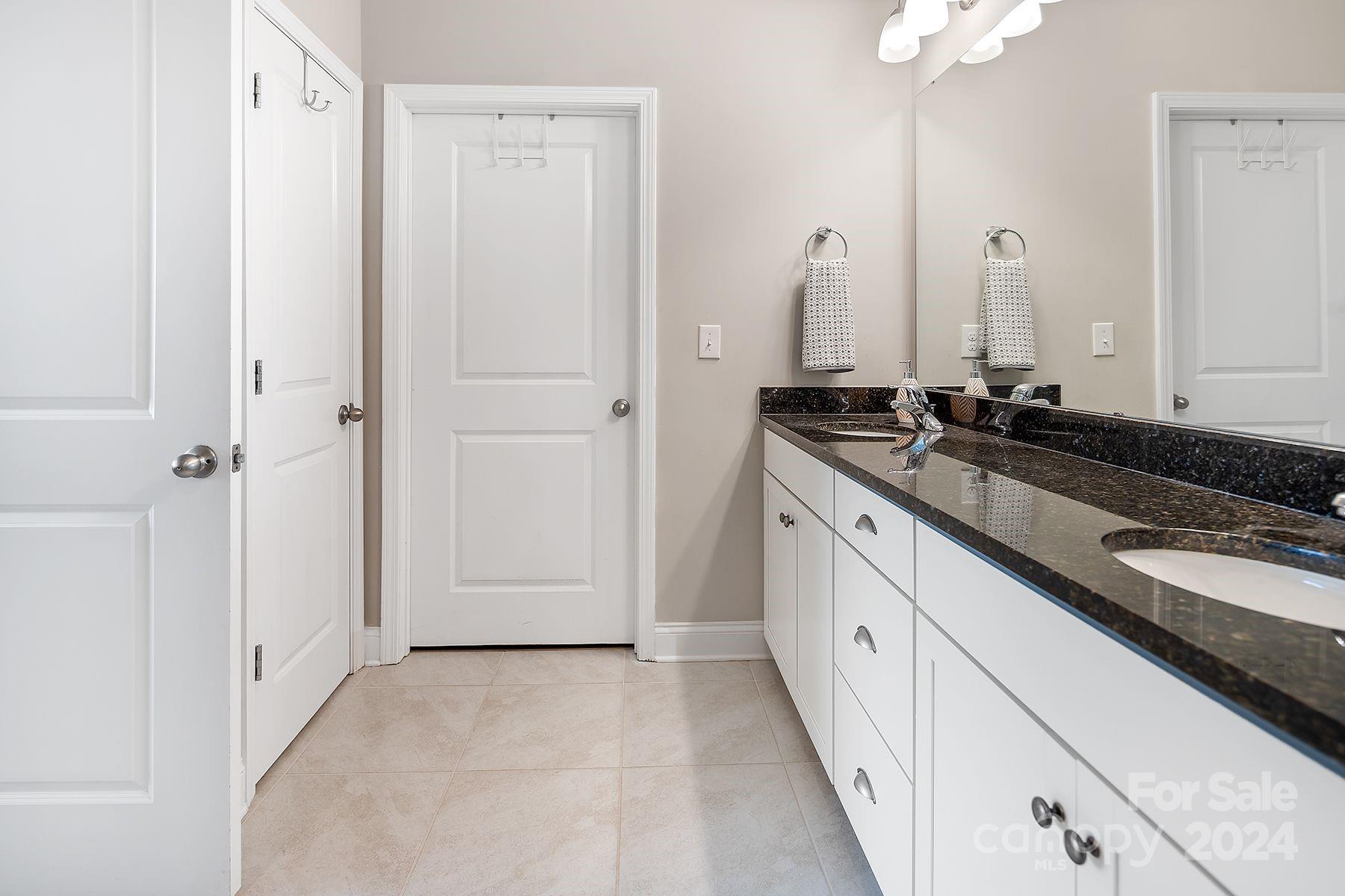 118 East Northstone Road Mooresville, NC 28115 - Photo 16 of 33 a spacious bathroom with a granite countertop sink and a mirror