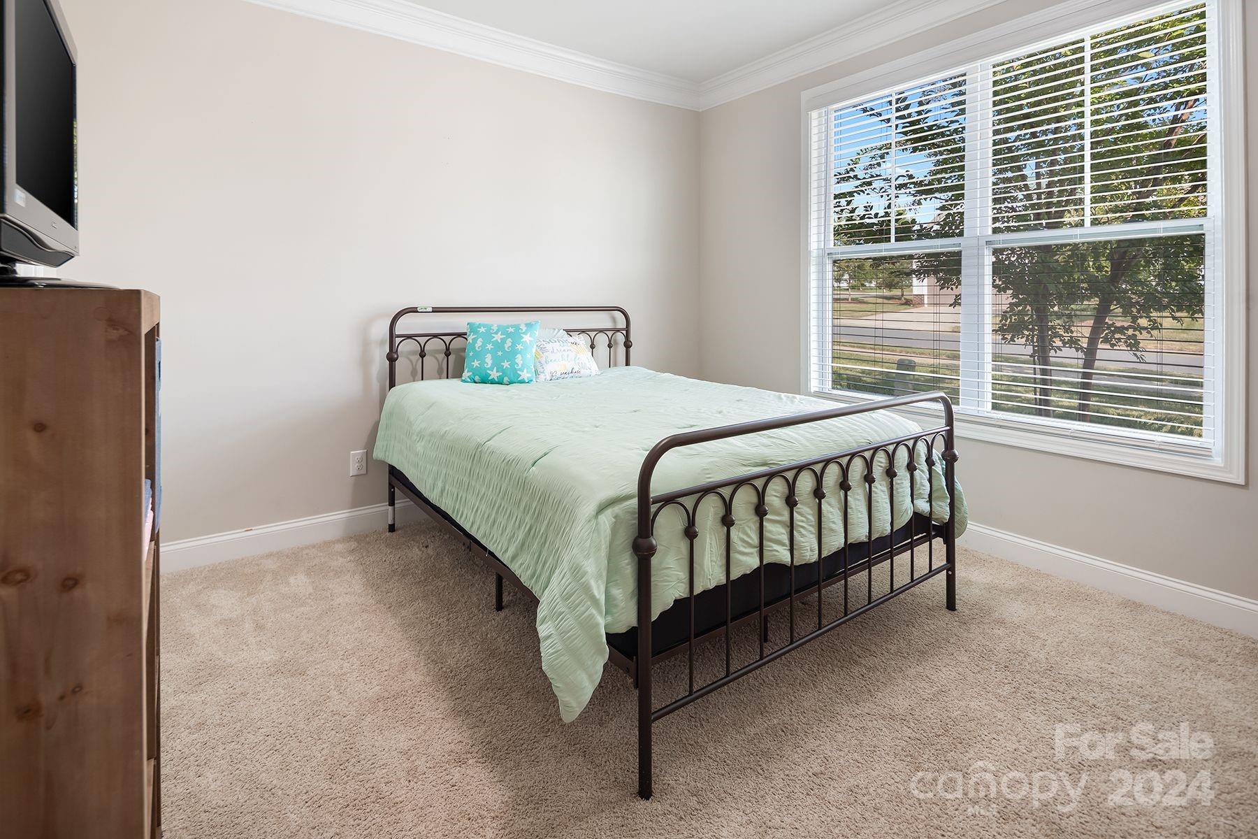 118 East Northstone Road Mooresville, NC 28115 - Photo 20 of 33 a bedroom with a bed window and a flat tv screen on dresser