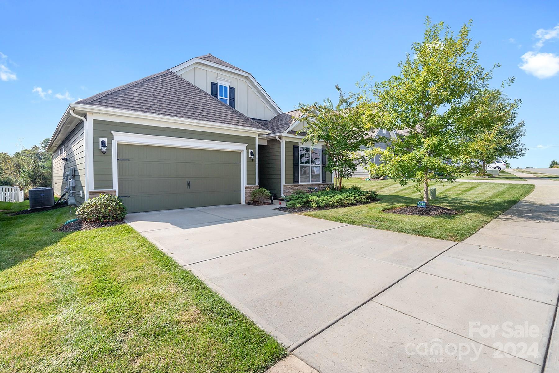 118 East Northstone Road Mooresville, NC 28115 - Photo 2 of 33 a front view of a house with a garden and plants