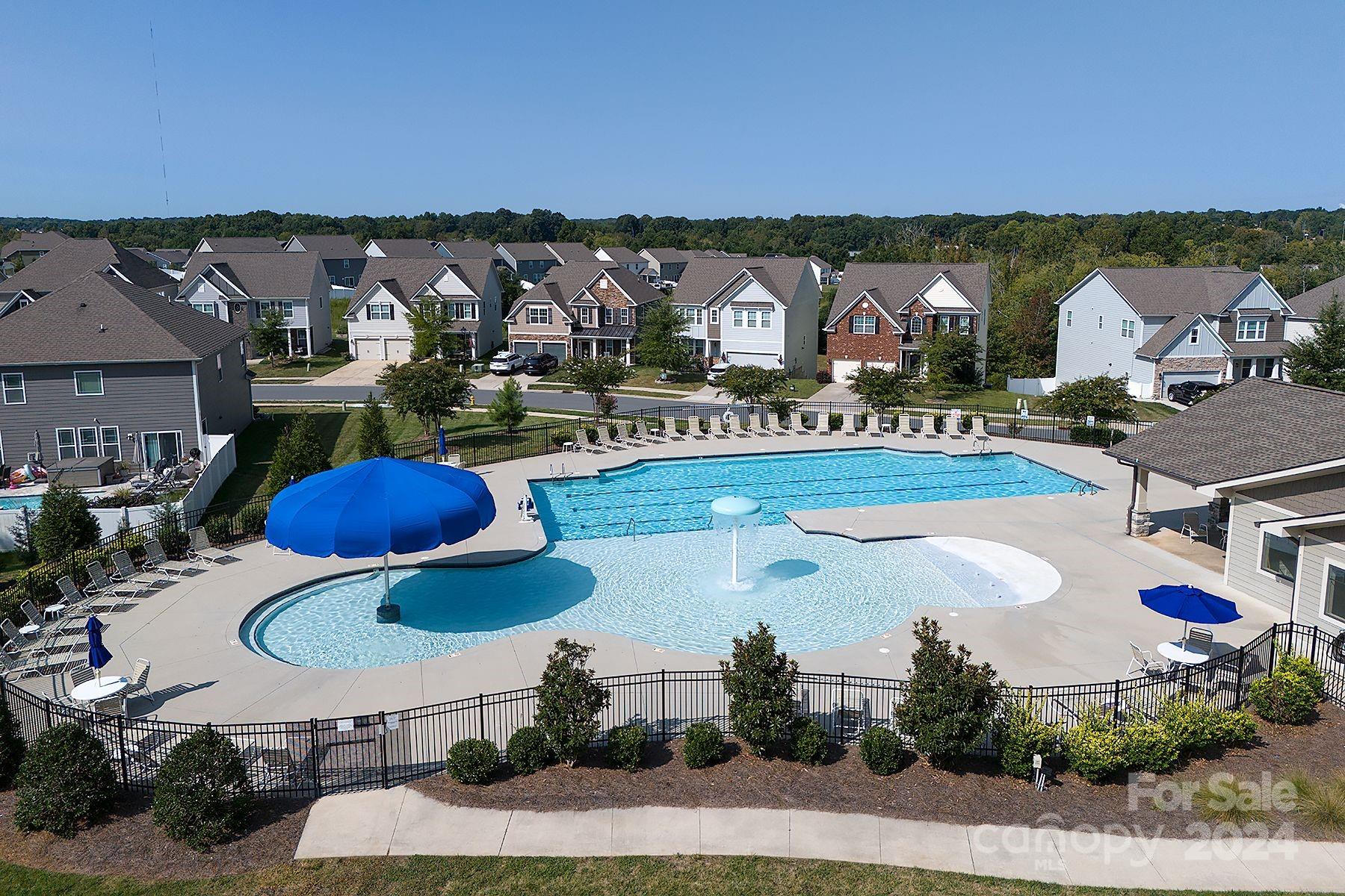 118 East Northstone Road Mooresville, NC 28115 - Photo 27 of 33 a view of a swimming pool with a table and chairs