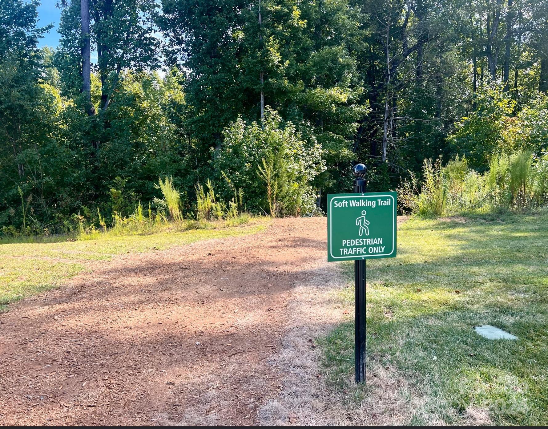 118 East Northstone Road Mooresville, NC 28115 - Photo 29 of 33 a street sign on a sidewalk next to a road