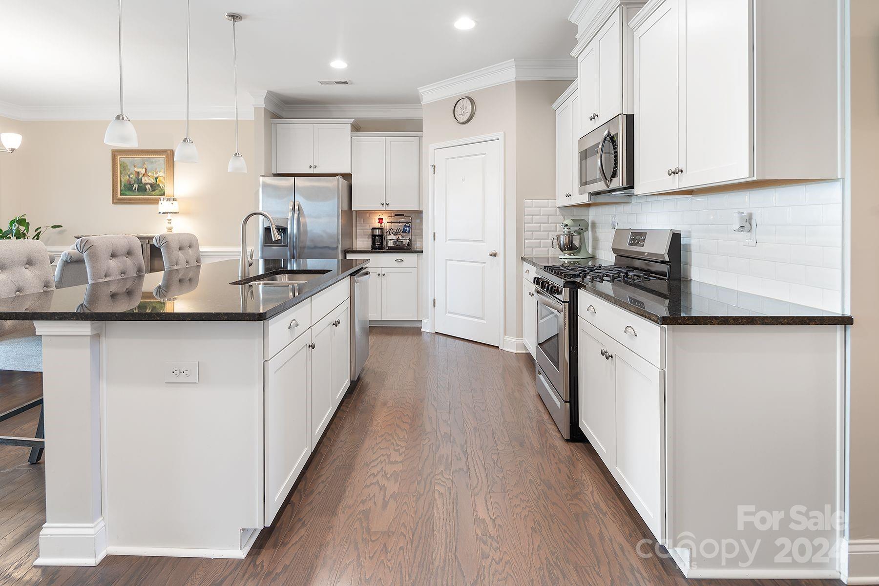 118 East Northstone Road Mooresville, NC 28115 - Photo 6 of 33 a kitchen with stainless steel appliances granite countertop a sink and cabinets