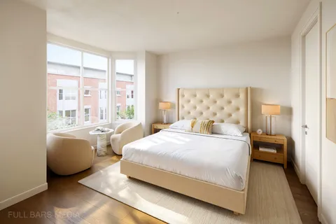 a bedroom with a bed and a large window