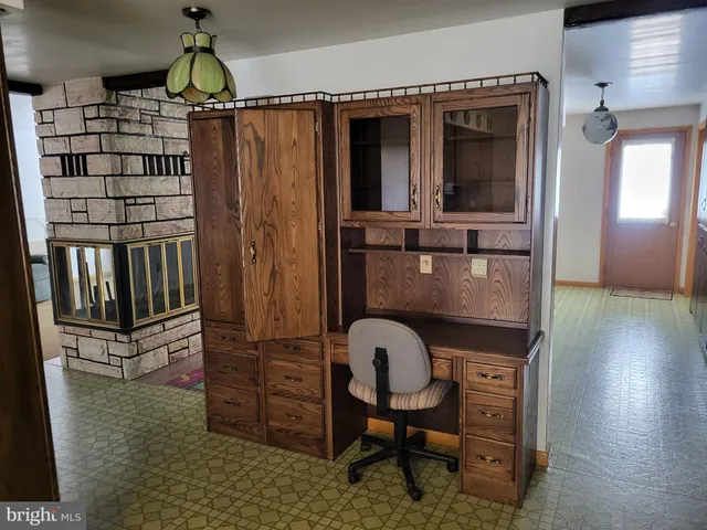 a kitchen with a refrigerator and a wooden cabinets