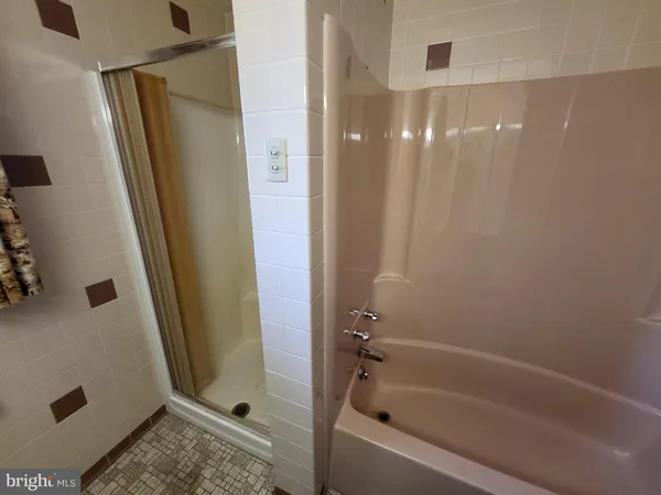 a bathroom with a shower and a tub