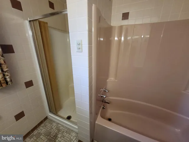 a bathroom with a shower and a tub