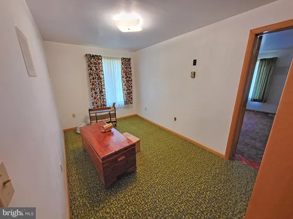 wooden floor with pool table and window
