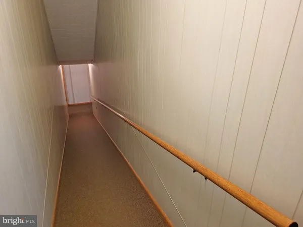 a view of hallway with wooden floor