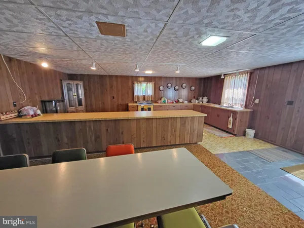 a large kitchen with a table and chairs