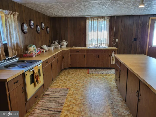 a kitchen with stove and cabinets