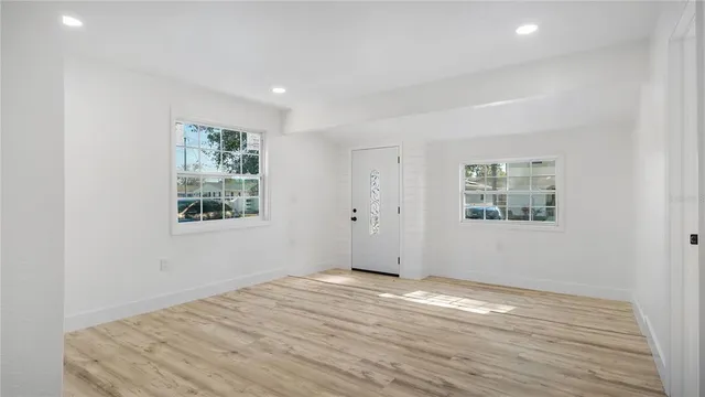 wooden floor in an empty room with a window