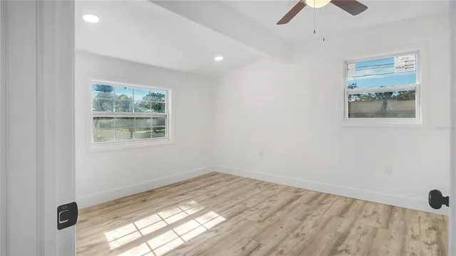 wooden floor in an empty room with a window