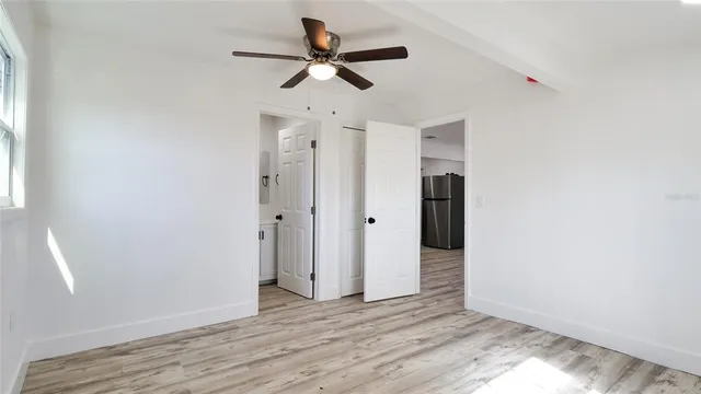 wooden floor in an empty room with a window