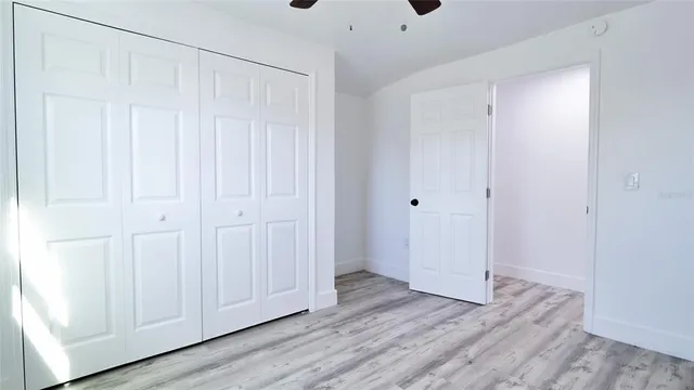 a view of room with window and wooden floor