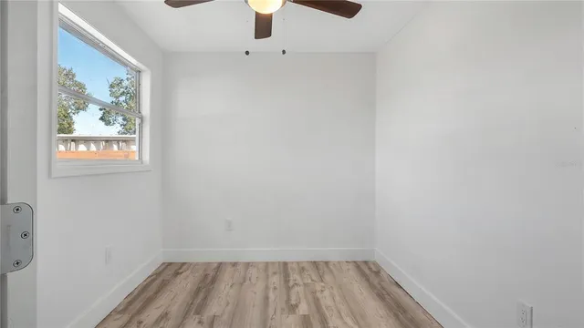 a view of a hallway with wooden floor and closet