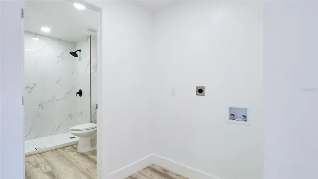 a bathroom with a shower a toilet and a shower