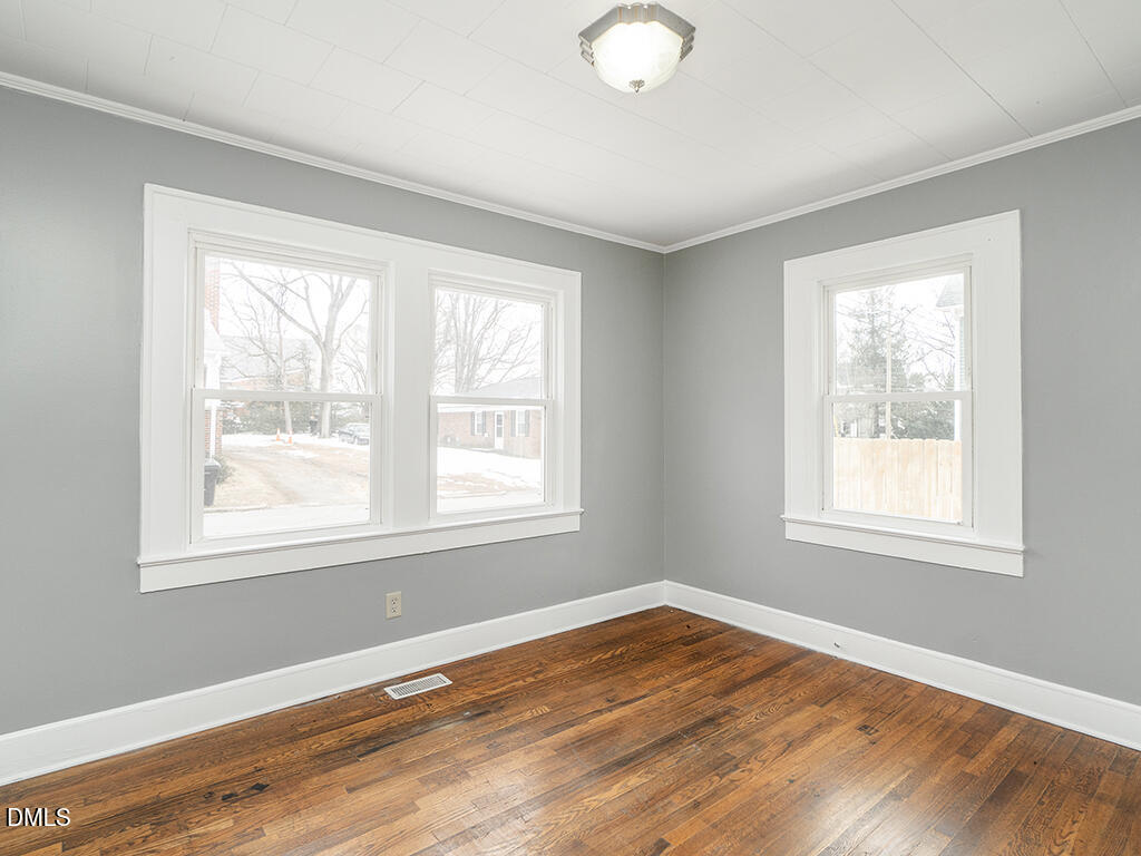133 Brooks Street Burlington, NC 27215 - Photo 13 of 24 a view of an empty room with wooden floor and a window