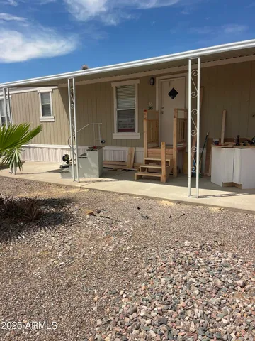 a view of a house with a backyard