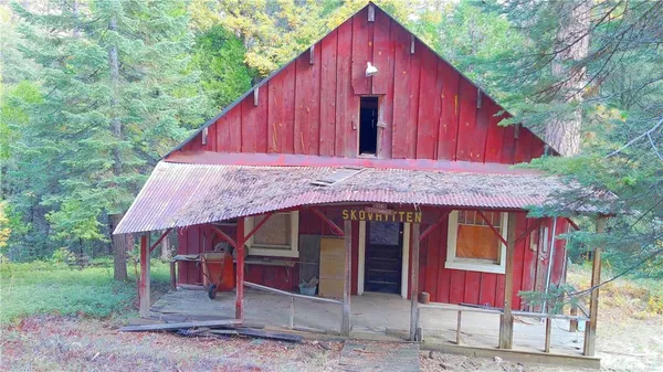 a view of a small house with roof deck