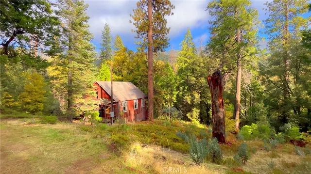 a view of a wooden house with a yard