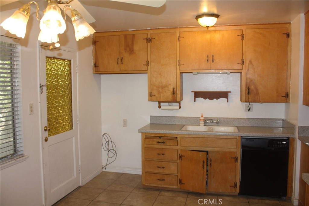 6458 Rhonda Road Riverside, CA 92504 - Photo 11 of 47 a bathroom with a granite countertop sink a mirror and a shower